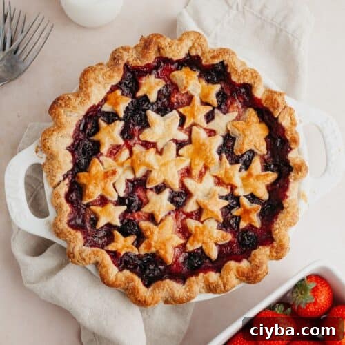 A mixed berry pie covered in star pastry cutouts.