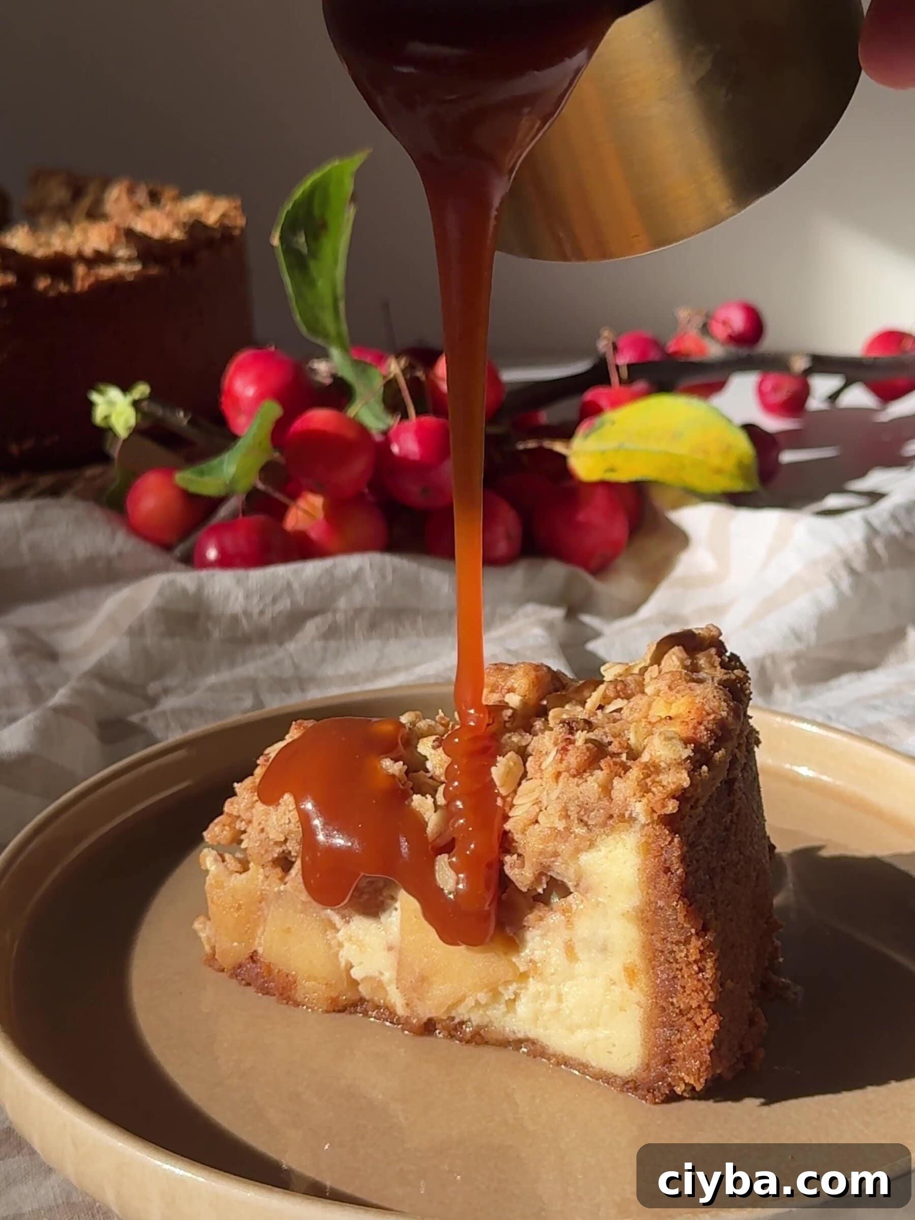 Drizzling caramel sauce over a slice of Apple Crumble Cheesecake
