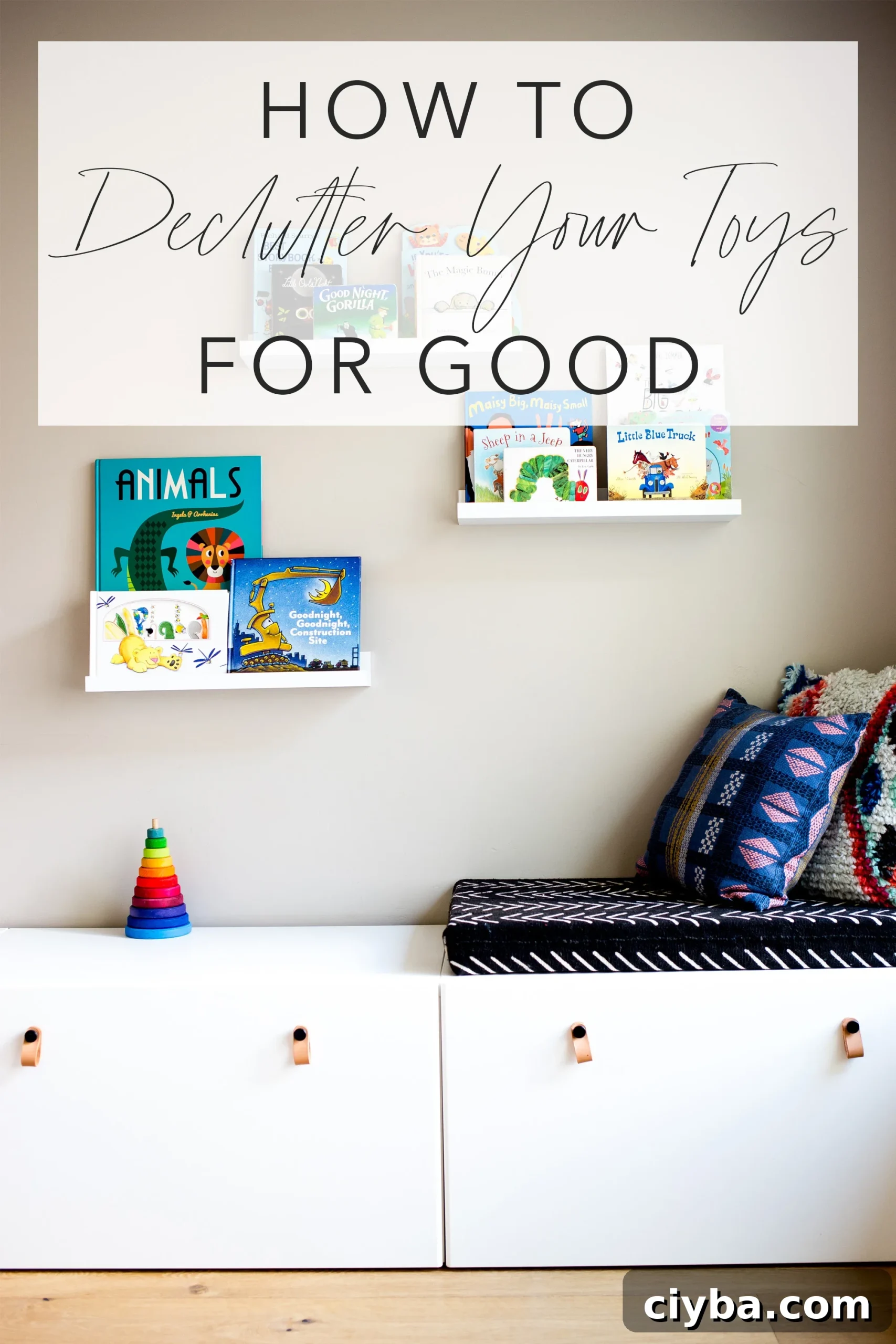 Play room with white modern toy storage bench IKEA and floating white shelves with kids books and title text "how to declutter your toys for good"
