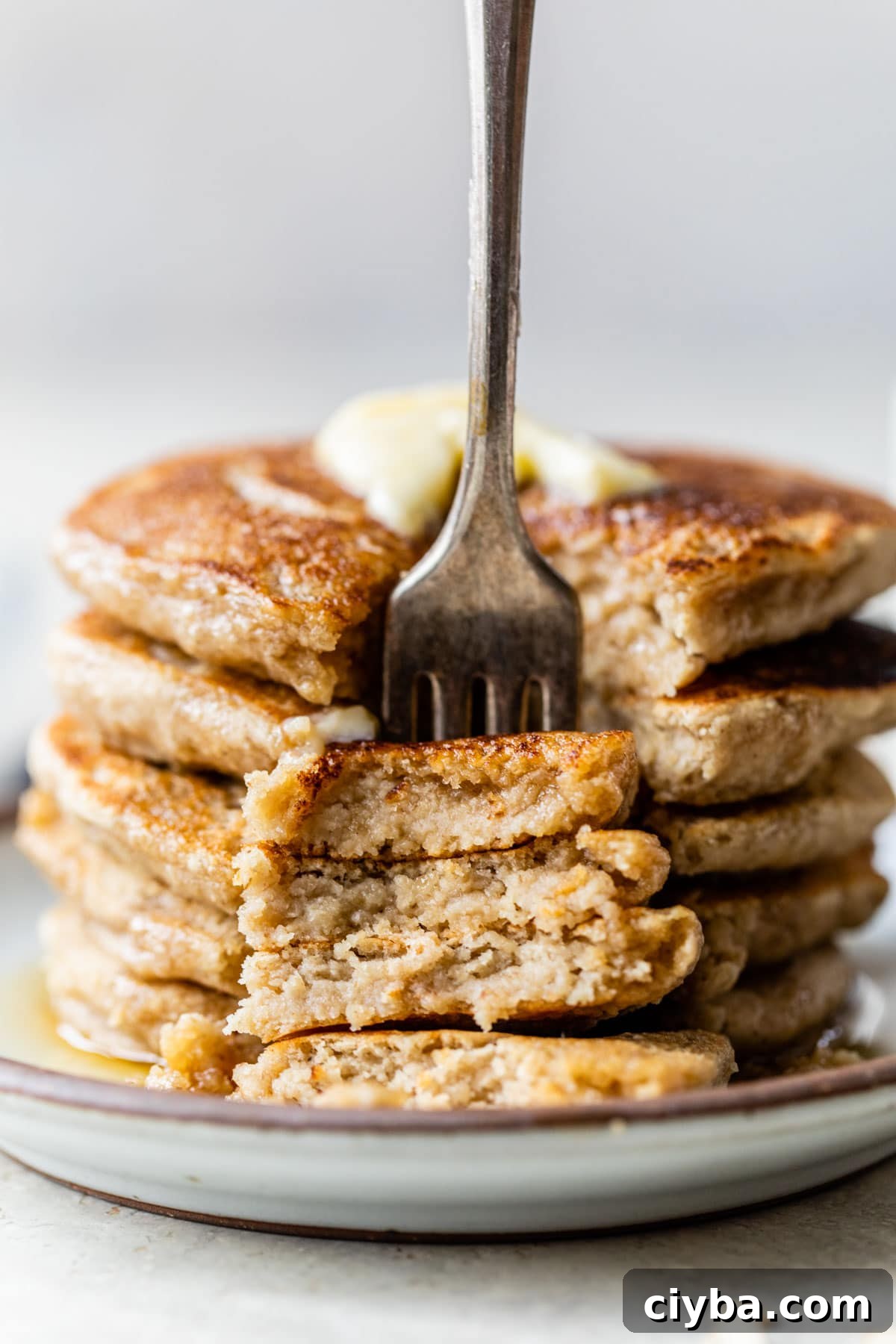 a stack of pancakes with a fork in them