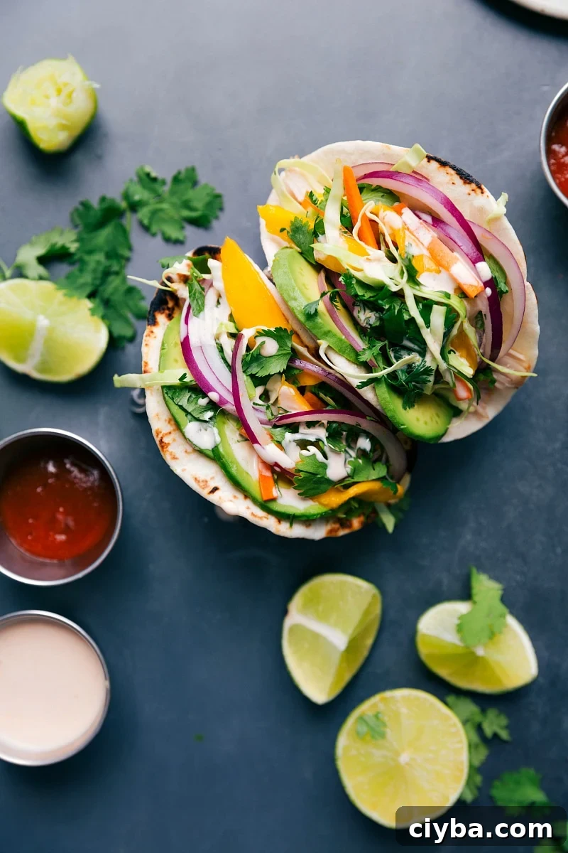 Asian chicken tacos stuffed with chicken, vegetables, and a complementary sauce, ready to be enjoyed.