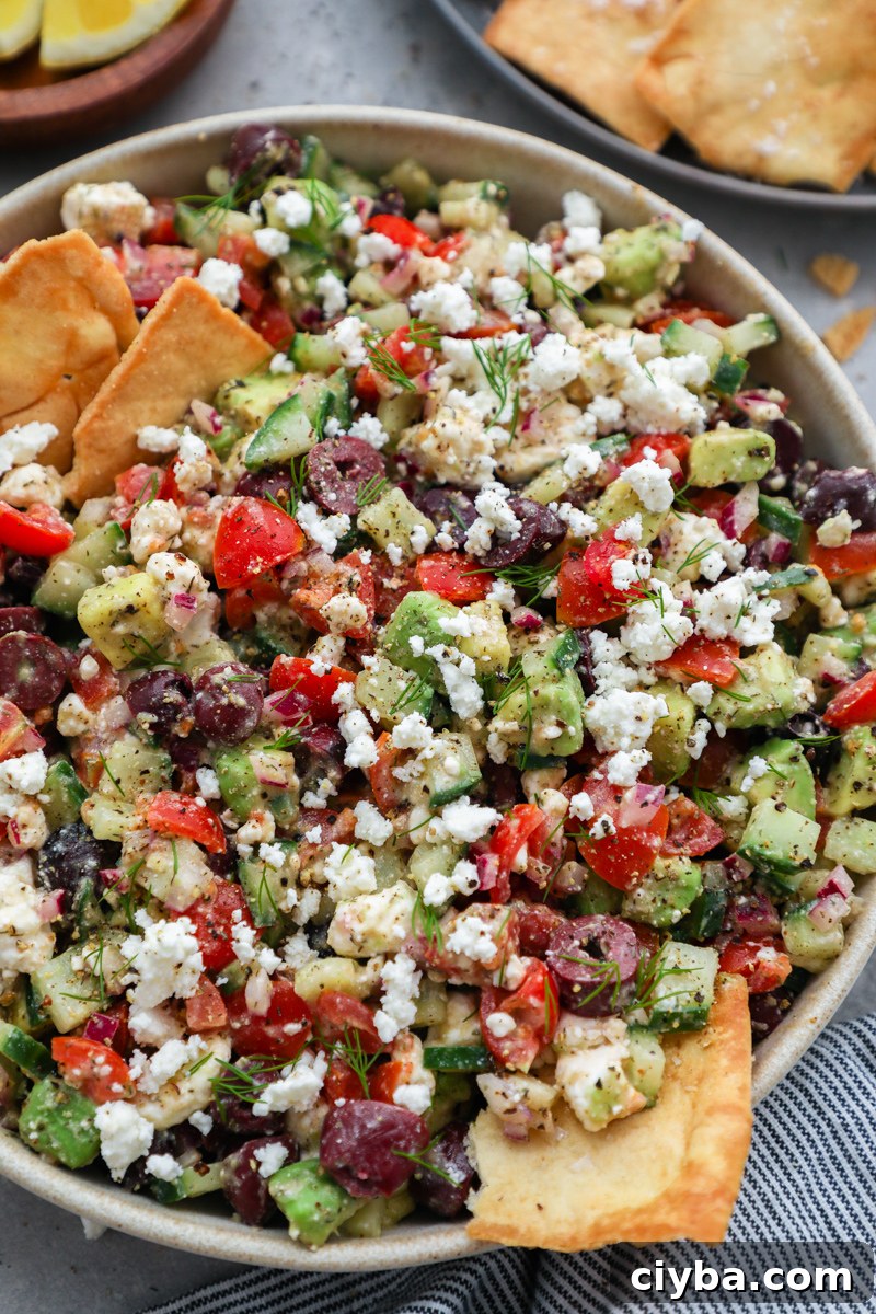 Mediterranean Avocado and Feta Salsa Recipe 9 A close of up photo of avocado Greek salsa sprinkled with crumbled feta and fresh dill on top