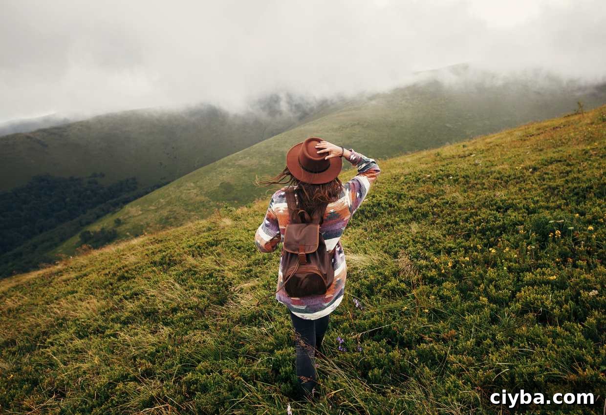A woman standing on a green hillside.