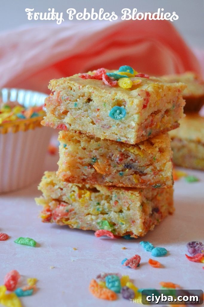 Fruity Pebbles Blondies Recipe: Chewy, Colorful Treats 2 A trio stack of fruity pebbles blondies with pieces of cereal