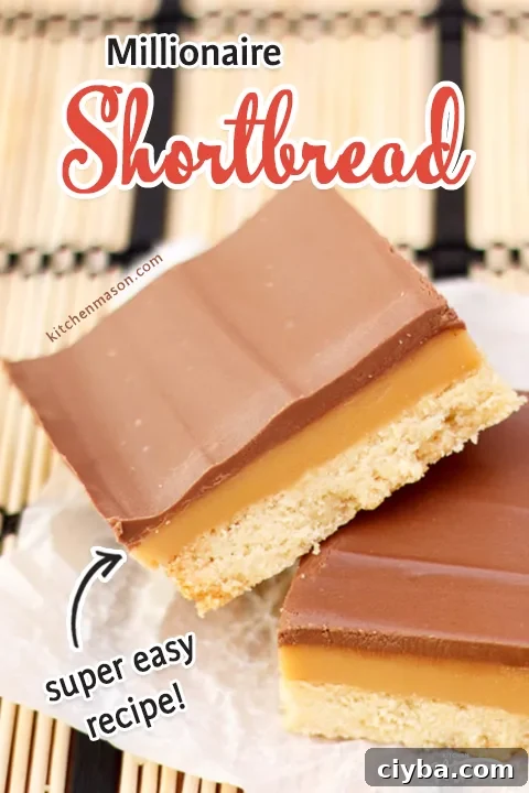 A piece of millionaire shortbread stacked on top of another on a cream and white placemat.