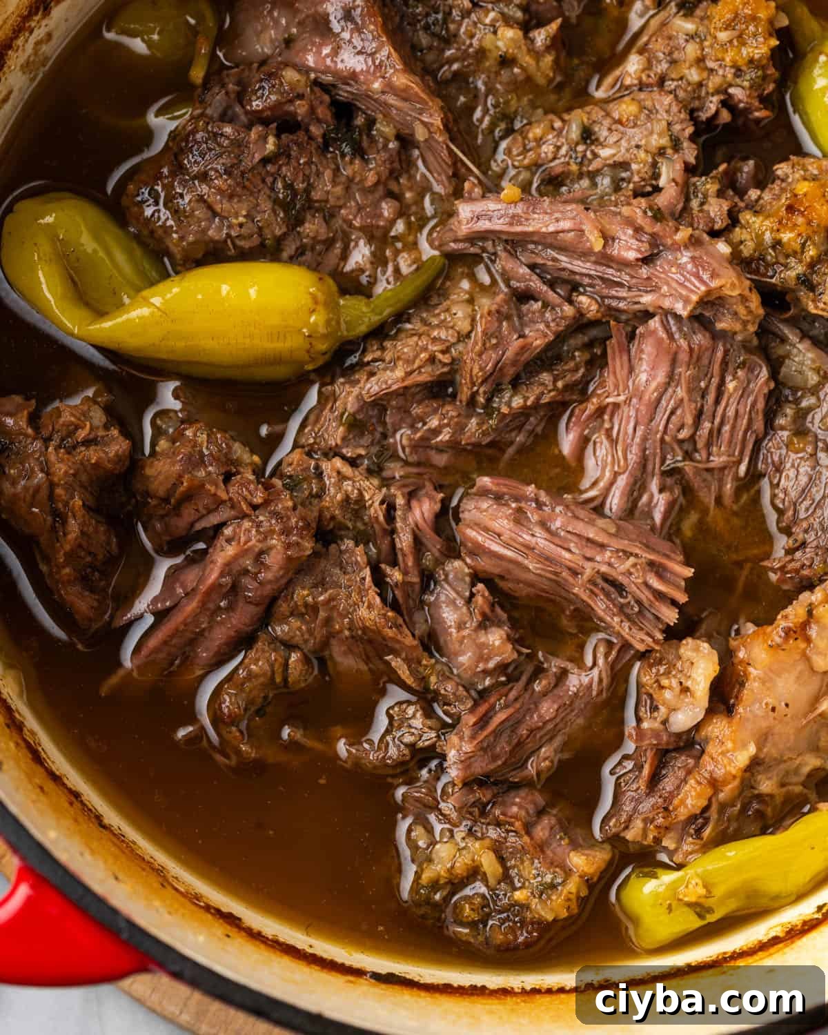 Cooked Mississippi pot roast in a large dutch oven pot. 