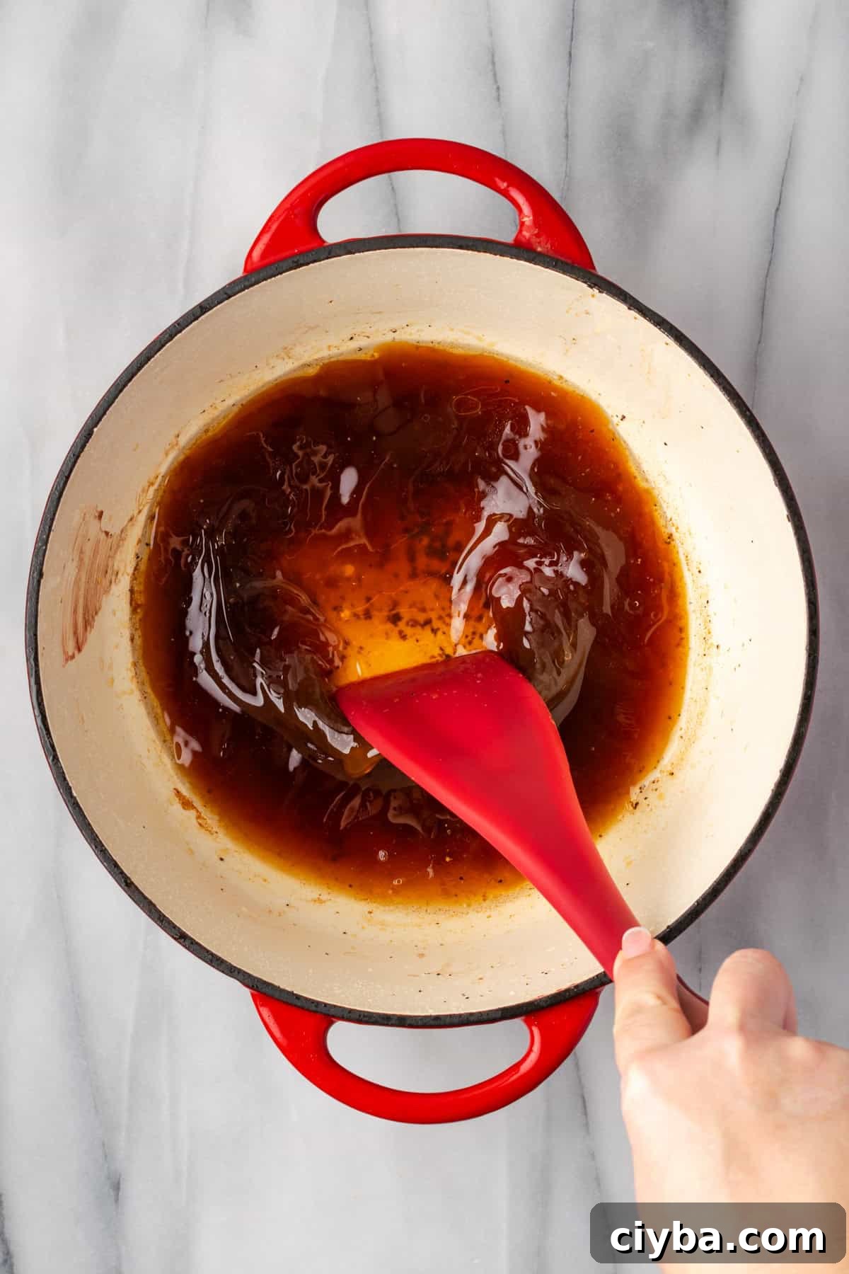 Broth being used to deglaze the bottom of the pot. 