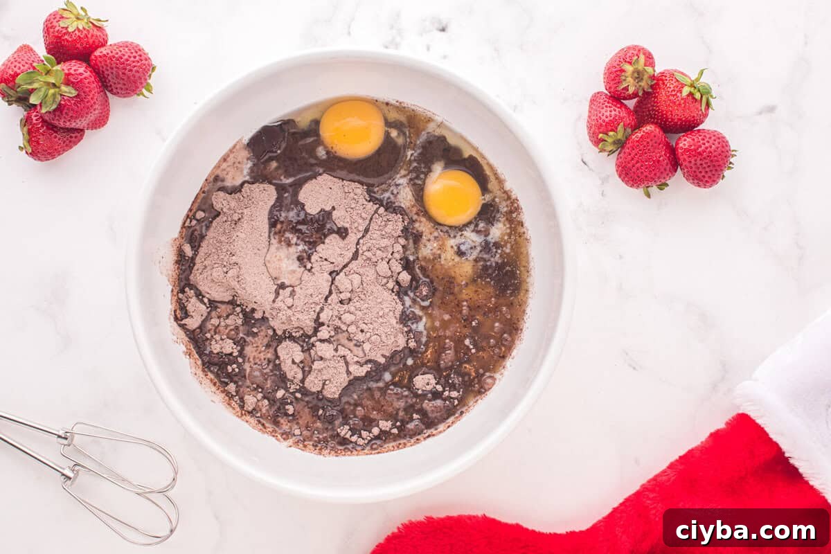 Santa Hat Brownies: Festive Chocolate Holiday Treats 6 brownie batter ingredients in a mixing bowl, unmixed.