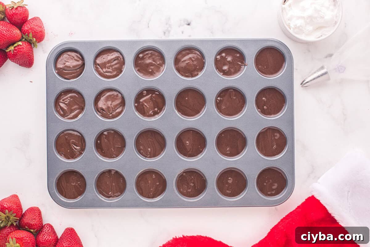 Santa Hat Brownies: Festive Chocolate Holiday Treats 7 mini cupcake tin filled with brownie batter.