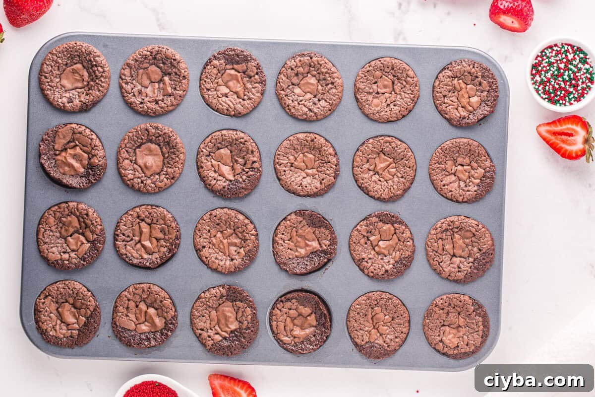 Santa Hat Brownies: Festive Chocolate Holiday Treats 8 baked brownie bites in a mini cupcake tin.