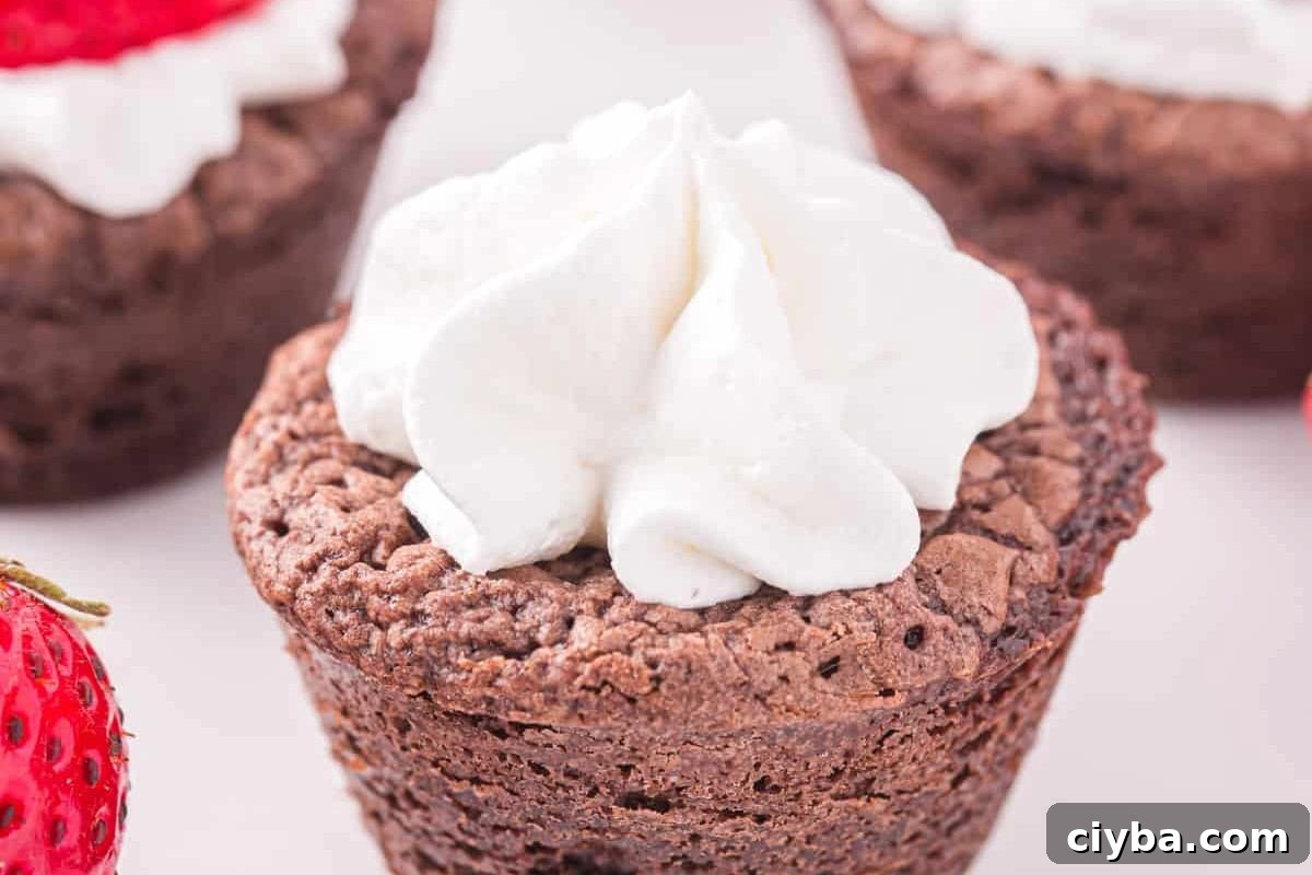 Santa Hat Brownies: Festive Chocolate Holiday Treats 10 whipped cream piped on top of a baked brownie bite.