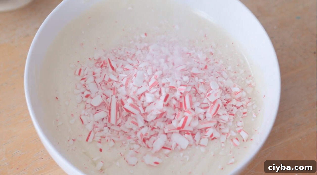 Bowl of melted white chocolate and crushed candy canes.