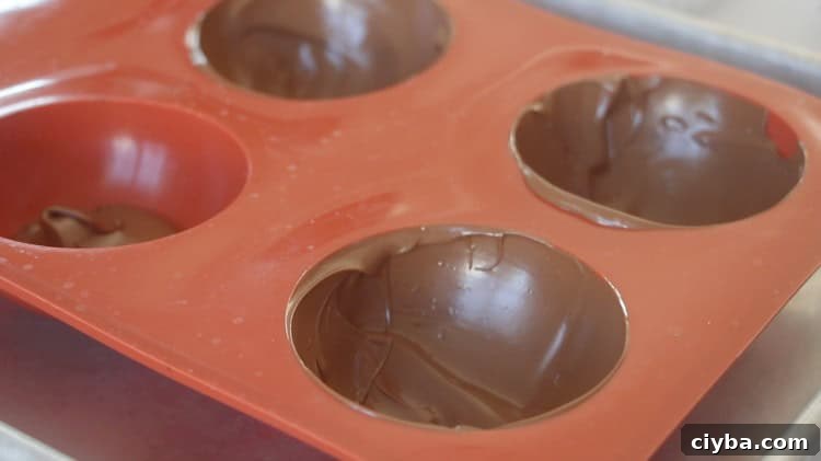 silicone chocolate mold with chocolate spooned inside
