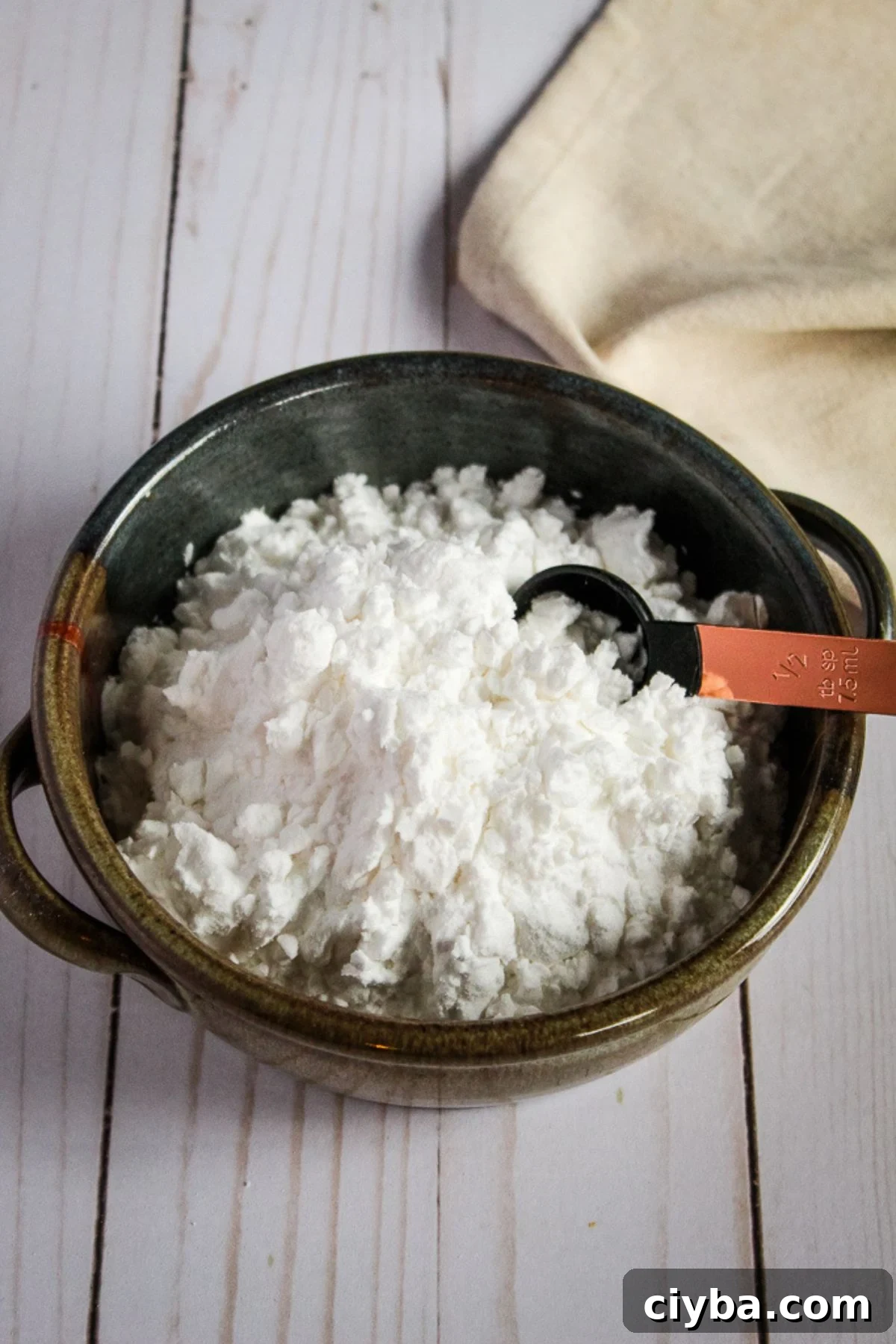bowl of potato starch with a measuring spoon