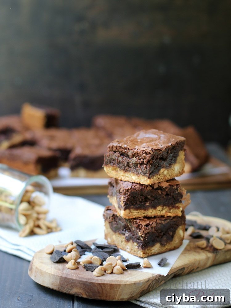 Chewy Peanut Butter Blondie Brownies 2 A three stack of Peanut Butter Blondie Brownies on a cutting board with chocolate chips