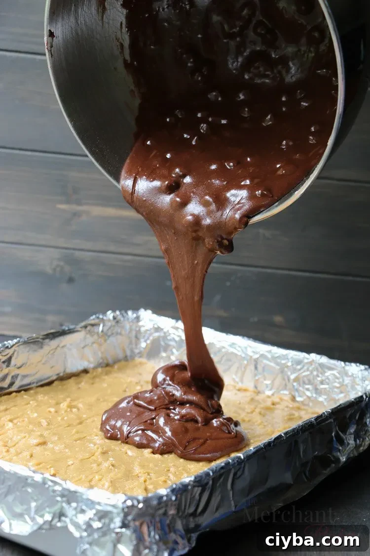 Chewy Peanut Butter Blondie Brownies 7 Pouring brownie mix into pan on top of peanut batter