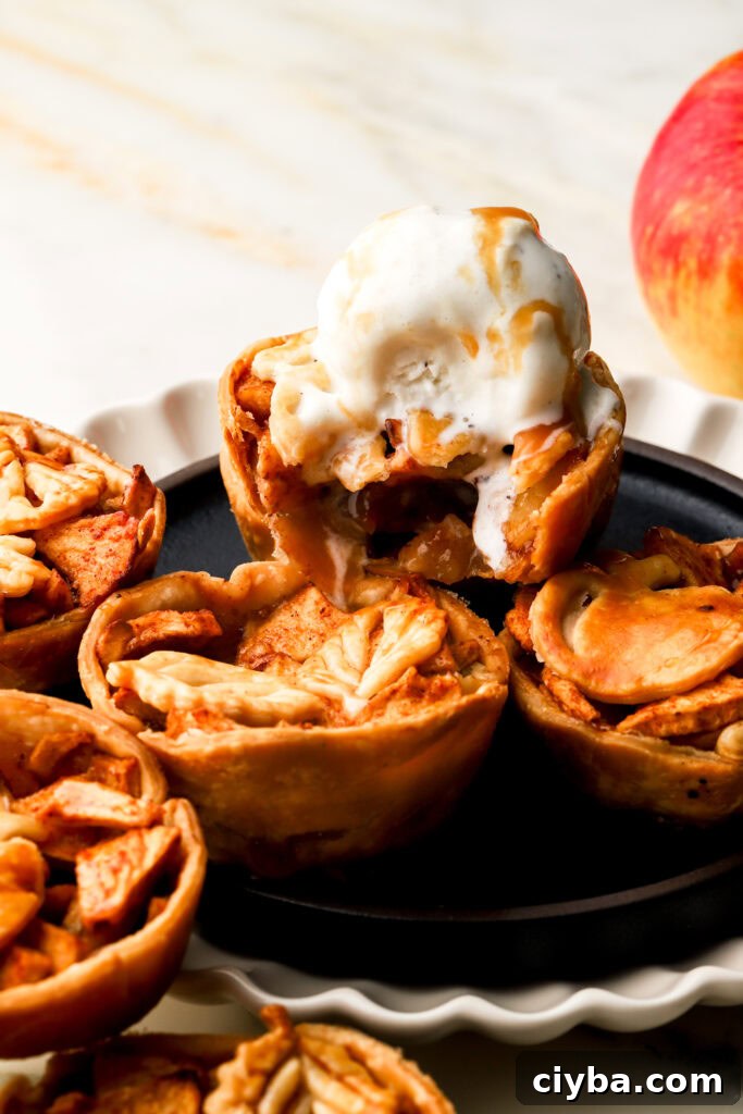 mini apples pies topped with vanilla ice cream