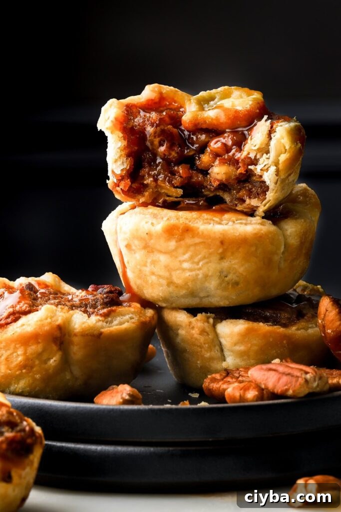 mini pecan pies stacked in a plate