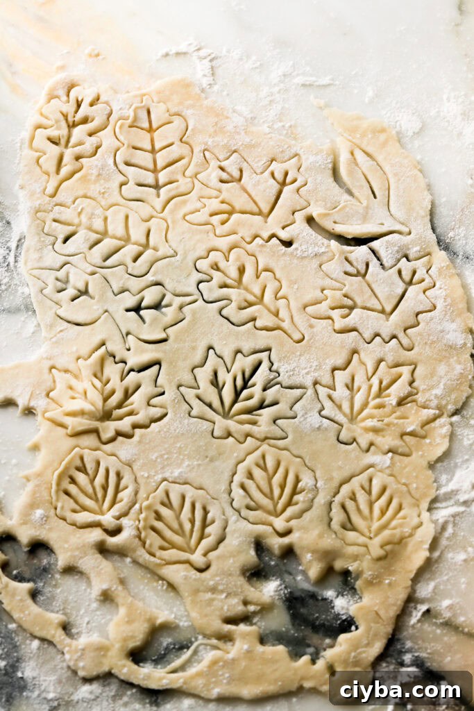 roll out pie crust dough and cut out desired shapes