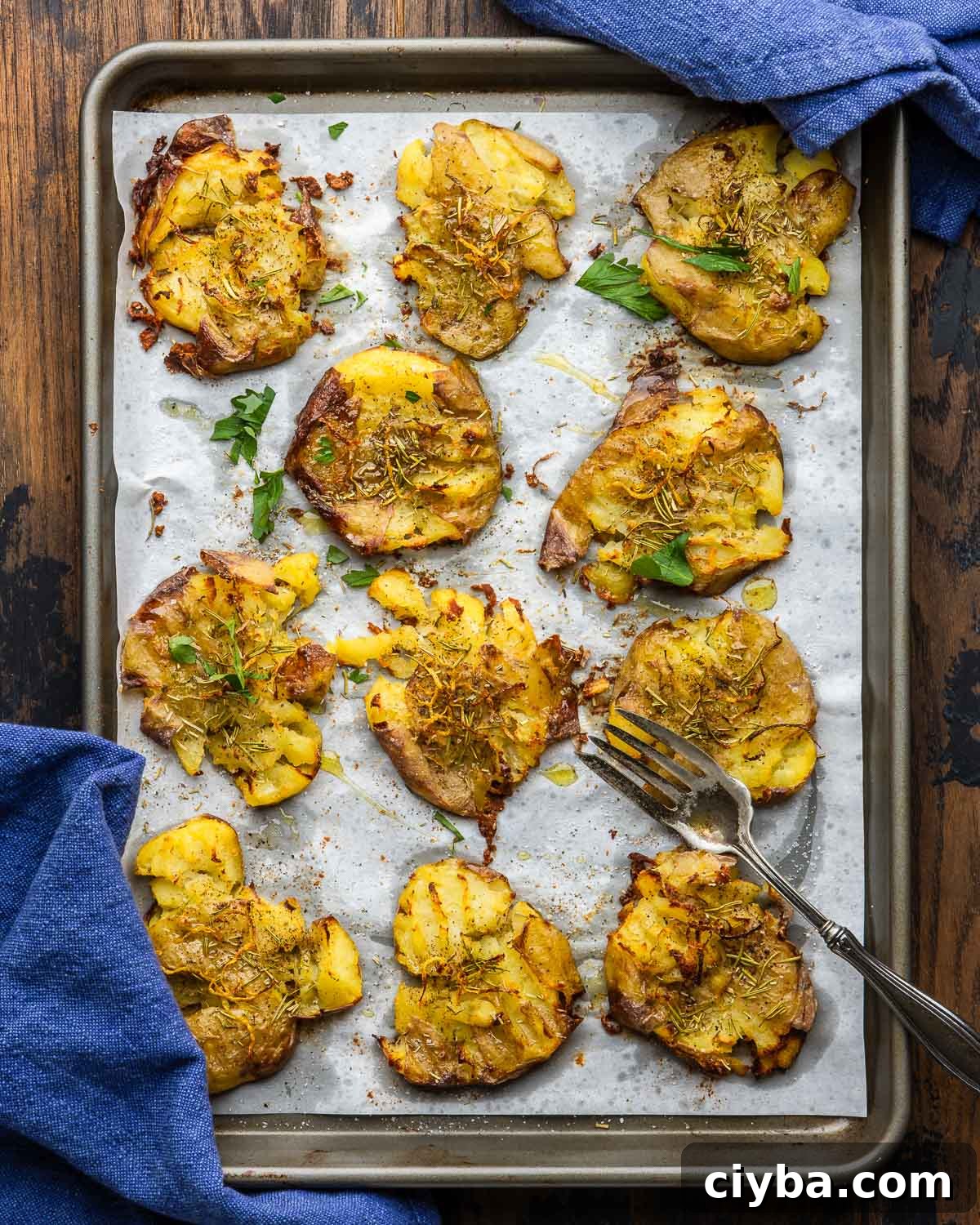 Large baking sheet with smashed potatoes.
