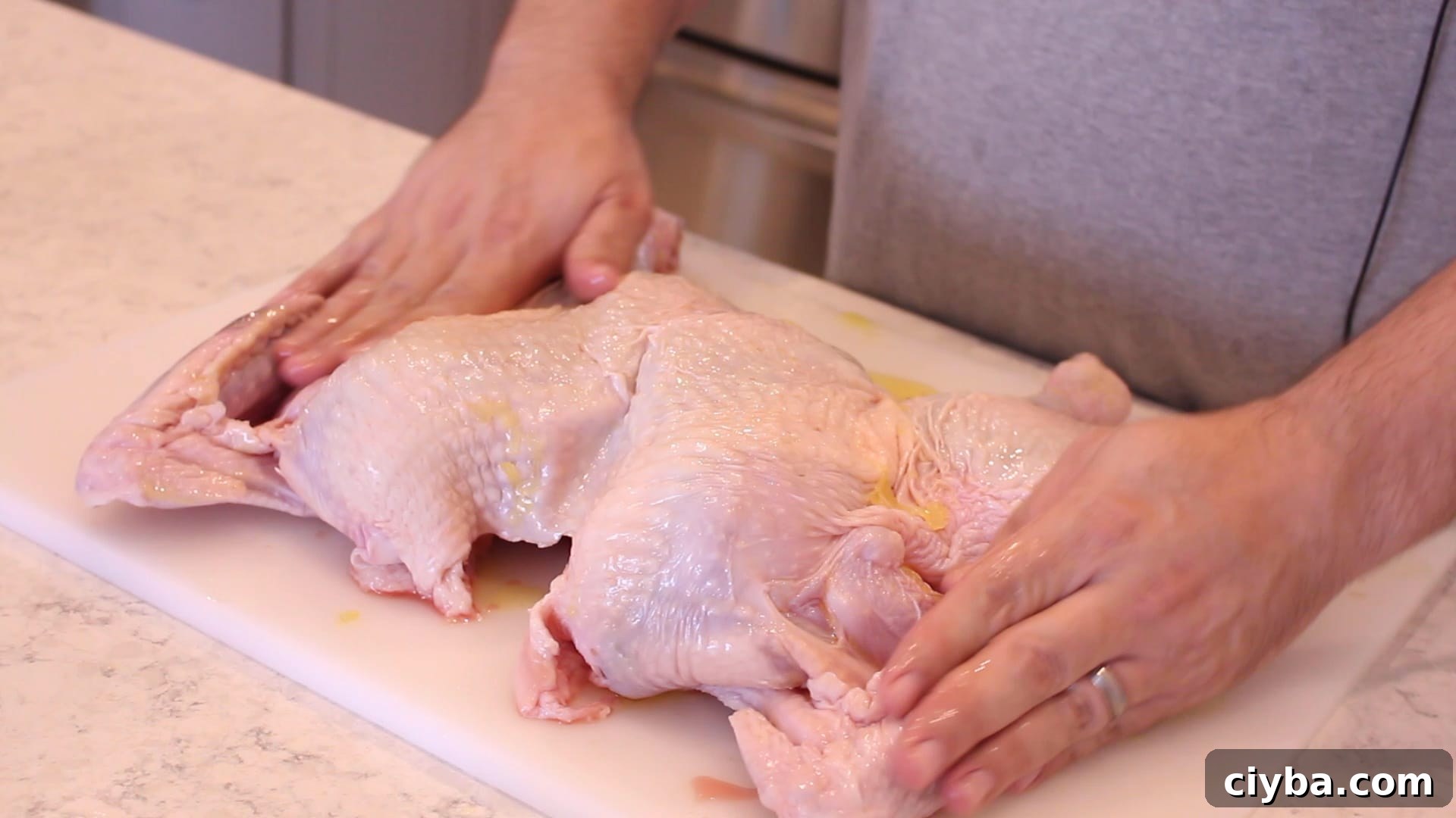rubbing a spatchcocked turkey down