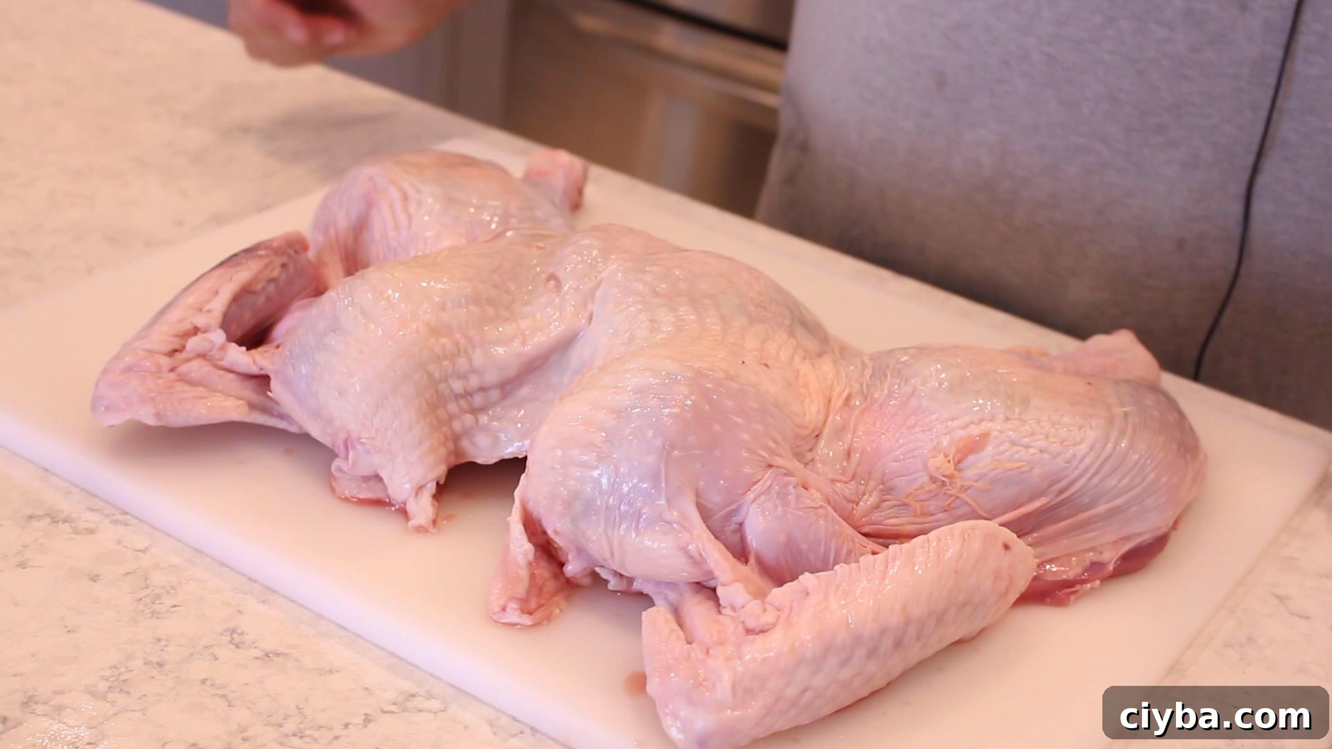 A flat spatchcocked turkey on a cutting board