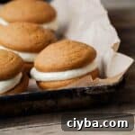 Gluten-Free Pumpkin Whoopie Pie with white frosting filling.