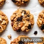 Gluten free pumpkin oatmeal cookies with raisins and walnuts peaking out the tops.