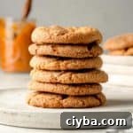 A stack of gluten-free pumpkin cookies on a wooden plate.