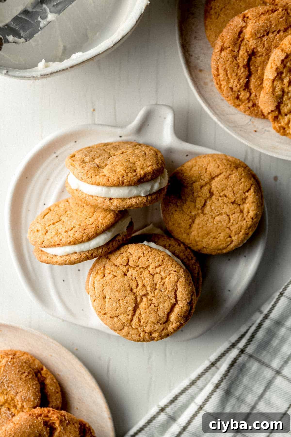 Gluten-free pumpkin sandwich cookies on a small pumpkin shaped plate.