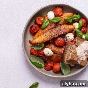 Caprese Chicken with Fresh Mozzarella and Basil 2 Caprese Chicken in a gray bowl on a white background