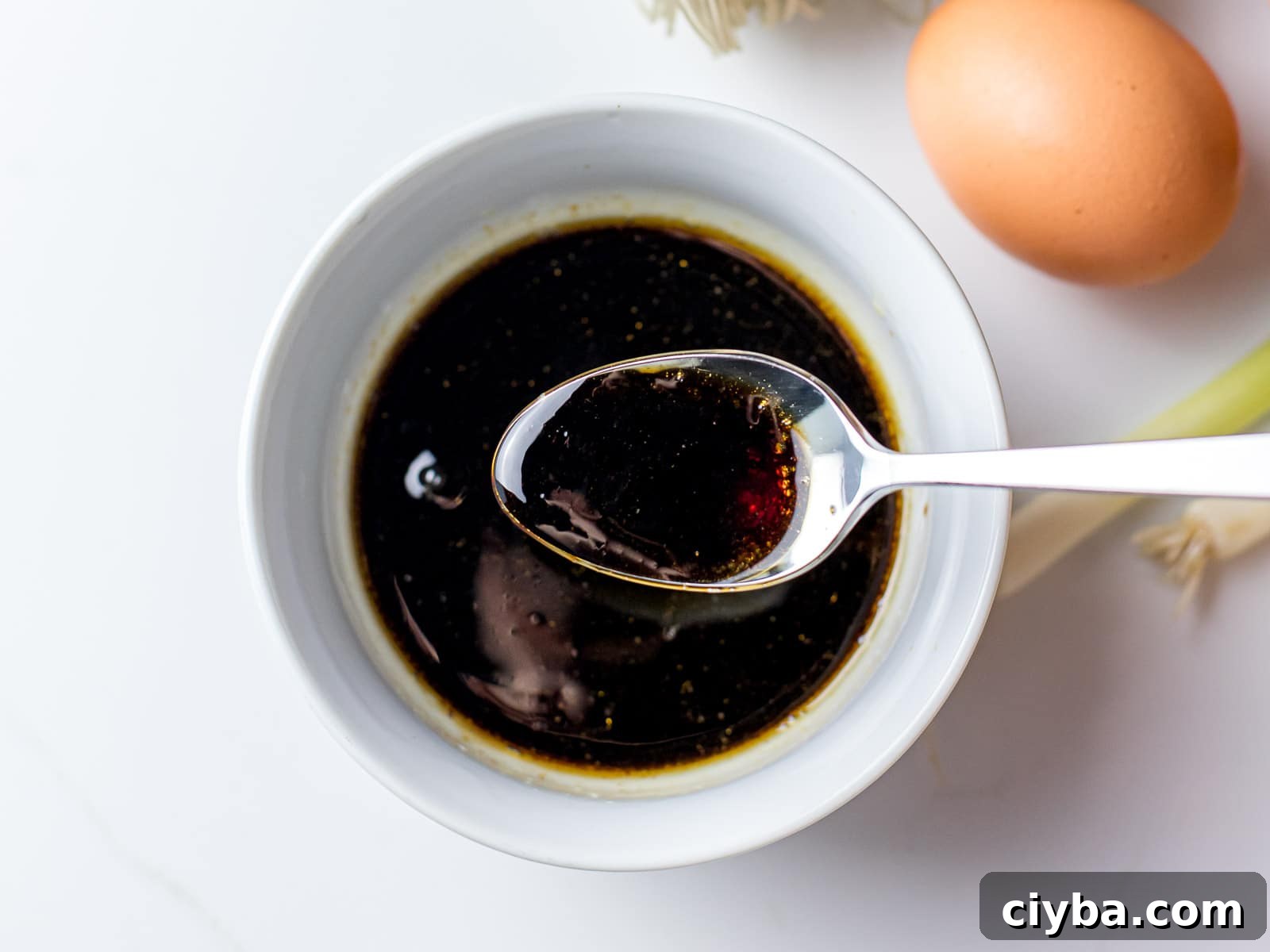 Authentic Japchae: Korean Glass Noodle Stir Fry Recipe 5 a spoonful of japchae sauce in a bowl
