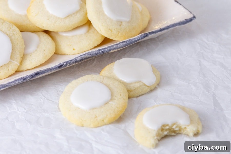 cookies on a parchment paper and some in a dish in the background.