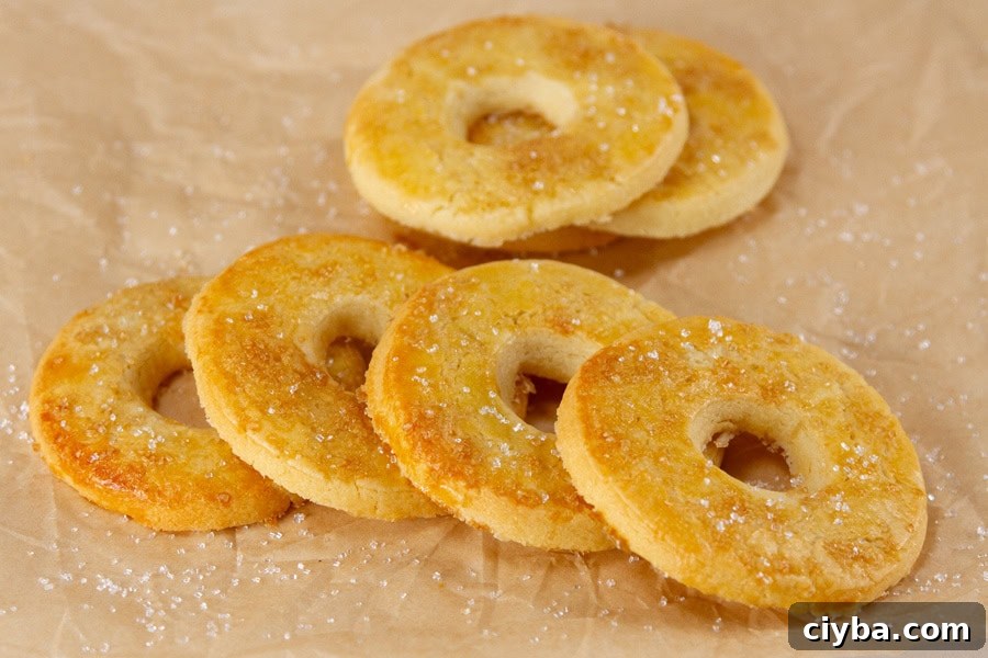horizontal crop of several cookies on a piece of brown parchment paper.