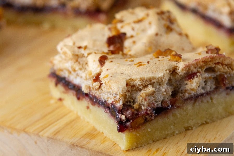 a bar cookie with 3 layers on a wooden cutting board.