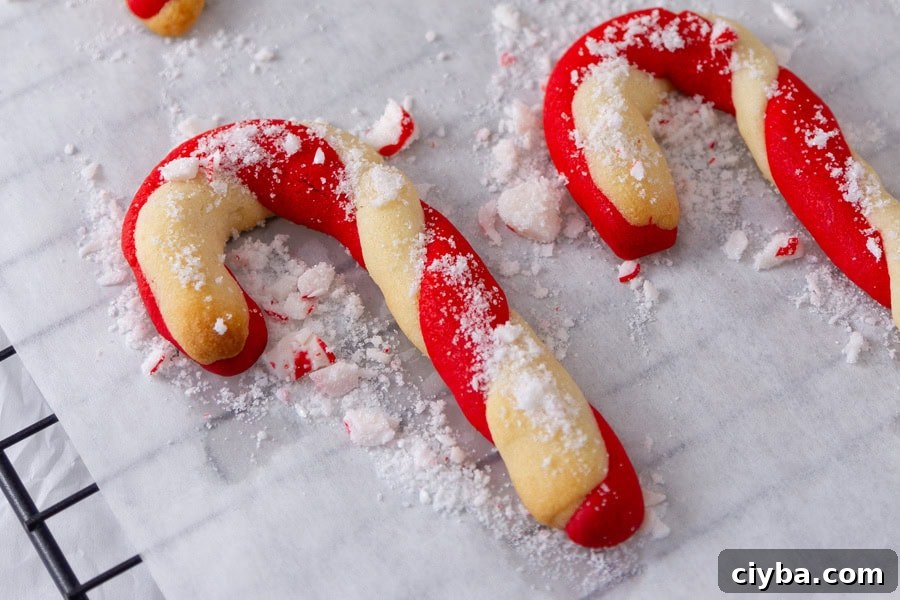 candy cane cookies on a parchment paper on a cooking rack.