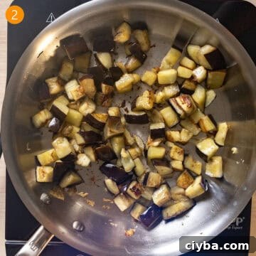 Eggplant frying in a pan.
