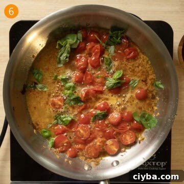 Basil and pasta water added to the cherry tomato and wine sauce.