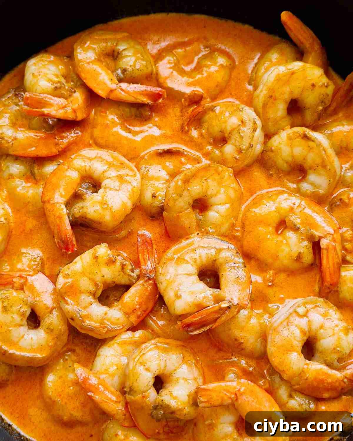 Close up of glossy creamy garlic prawns
