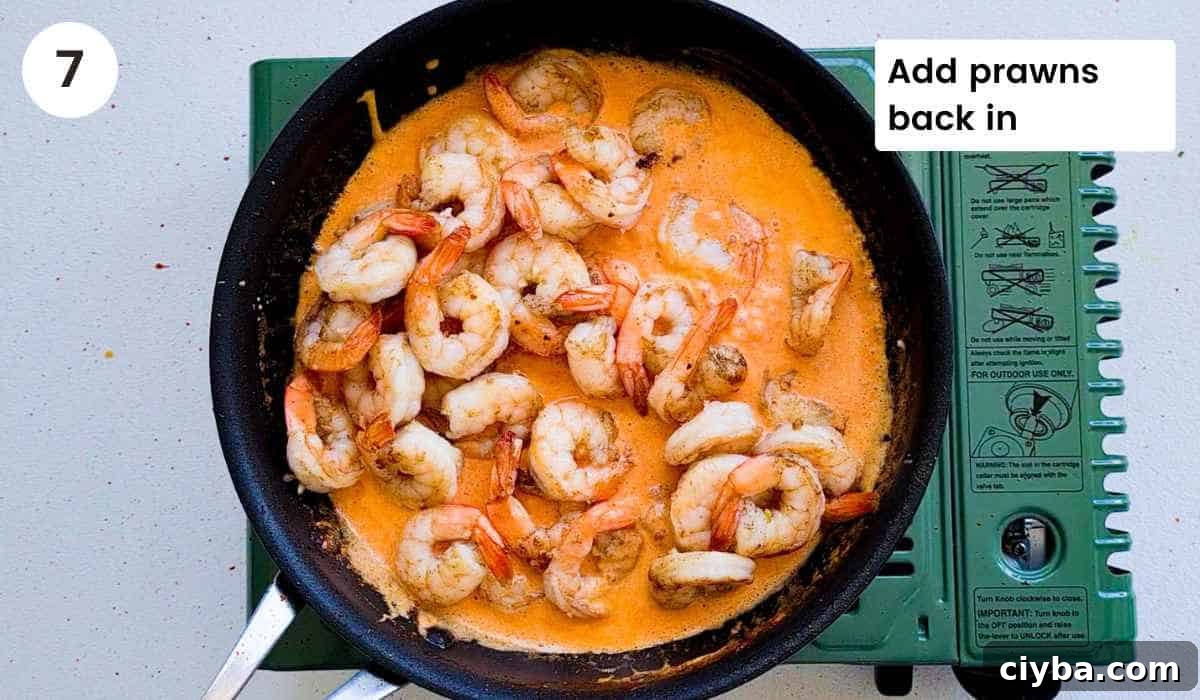 Sauteed shrimp (prawns) added into the creamy sauce with caption