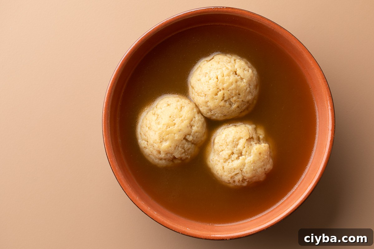 Matzo Balls Recipe: Classic, Light & Fluffy 2 bowl of three matzo balls in chicken broth