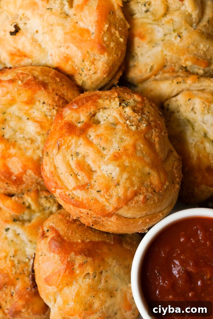 overhead shot of garlic knots and marinara sauce on the side