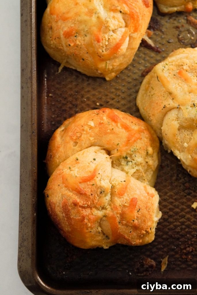crescent roll garlic knot on a baking sheet