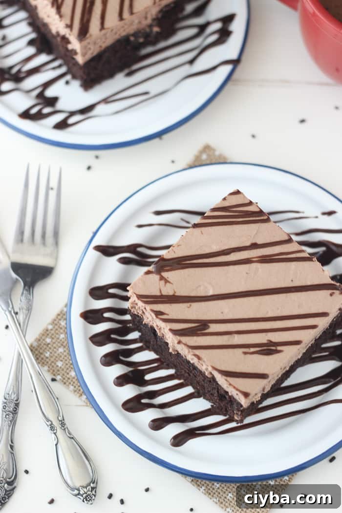 Dig into this Hot Chocolate Poke Cake! The Hot Chocolate Whipped Mousse topping is insane!