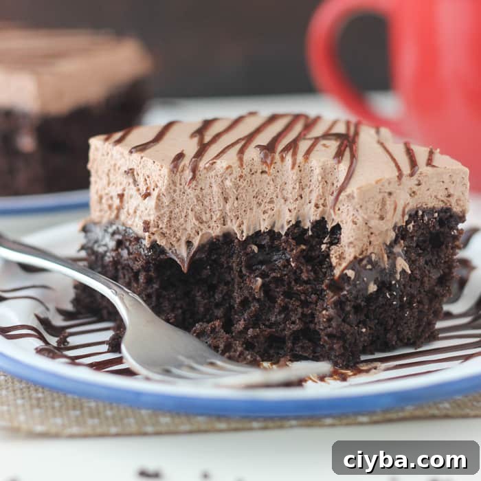 Hot Chocolate Poke Cake: Rich chocolate cake made with hot chocolate, soaked in hot fudge and topped with hot chocolate whipped cream.