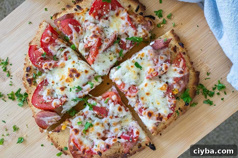 sliced keto pizza for one on a cutting board