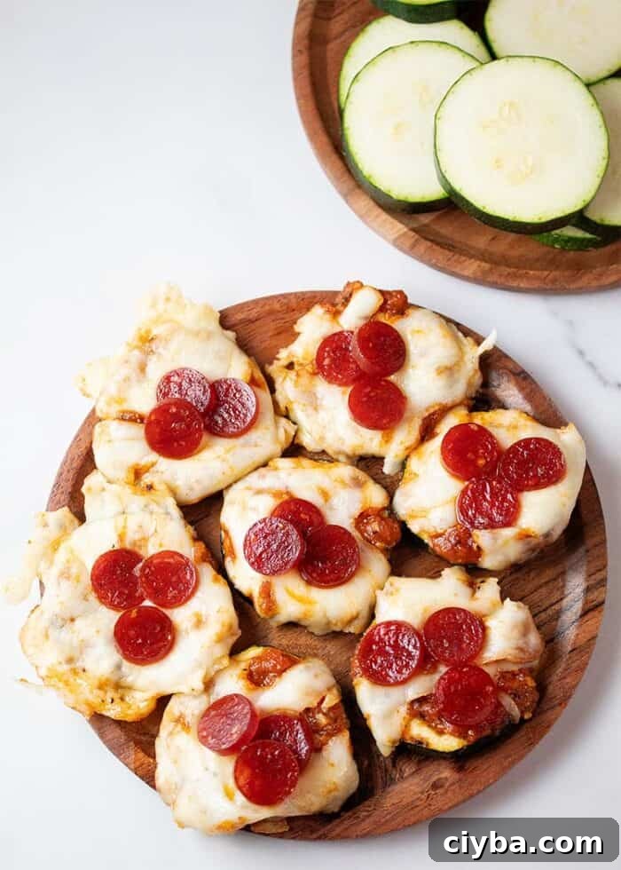 Keto Super Bowl Party Menu: Low-Carb Game Day Recipes 13 overhead view of seven zucchini pizza bites on a wooden plate ready to serve