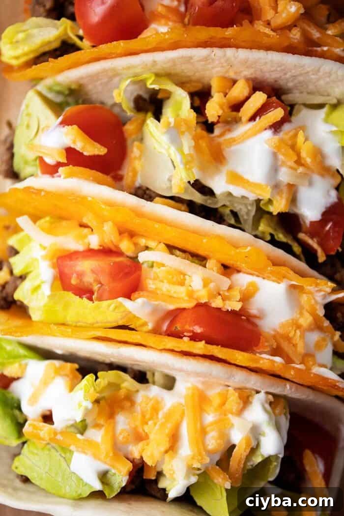Keto Super Bowl Party Menu: Low-Carb Game Day Recipes 18 overhead view of 4 tacos with 2 in cheese shells and 2 in tortillas with meat, lettuce, tomato, cheese and avocado