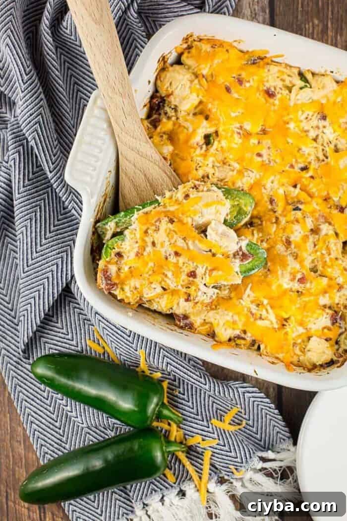 Keto Super Bowl Party Menu: Low-Carb Game Day Recipes 21 white casserole dish containing keto jalapeño popper chicken casserole next to jalapeños
