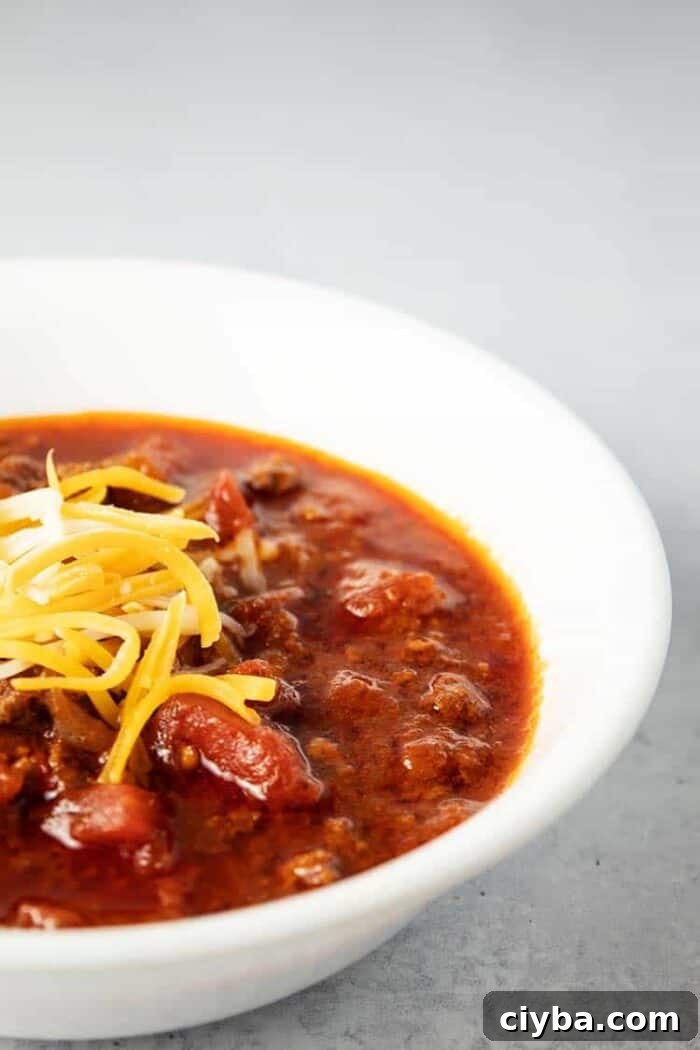 Keto Super Bowl Party Menu: Low-Carb Game Day Recipes 25 side view of white bowl containing keto chili topped with cheese
